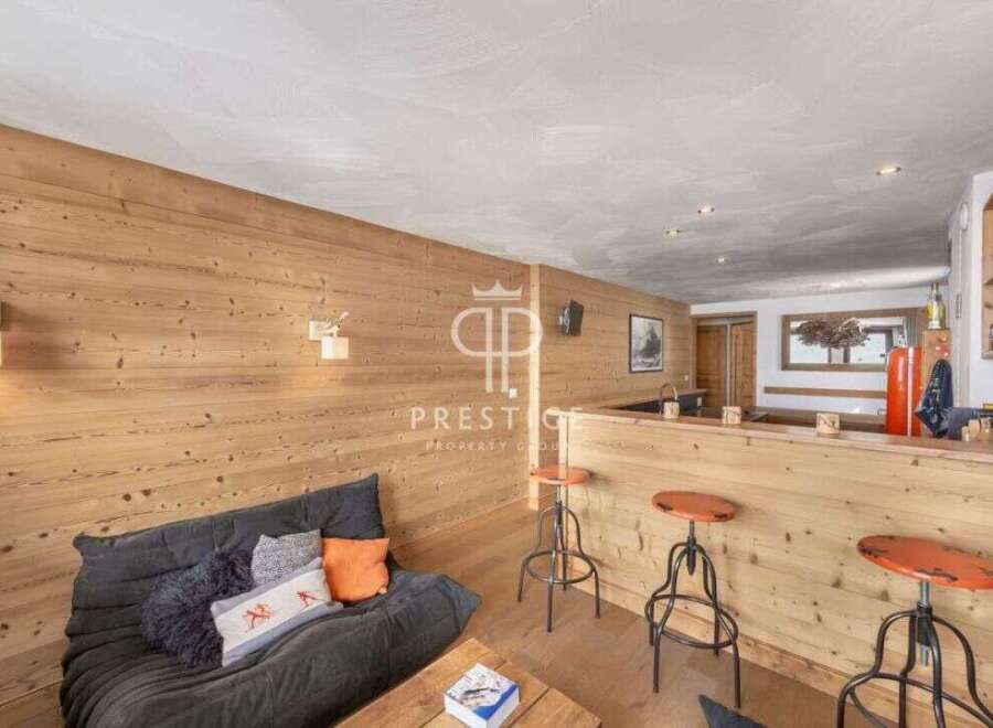 Discover the charm of this cozy property, featuring a stylish wooden interior and a comfortable seating area.