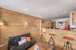 Discover the charm of this cozy property, featuring a stylish wooden interior and a comfortable seating area.