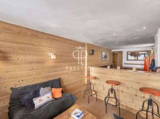 Discover the charm of this cozy property, featuring a stylish wooden interior and a comfortable seating area.