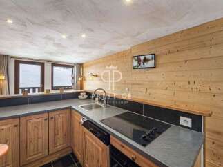 Discover a cozy kitchen with wooden cabinets and a sleek countertop, perfect for preparing meals.