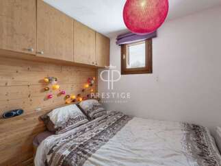 Cozy bedroom with wooden accents and a warm ambiance.