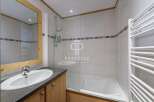 Discover a stylish bathroom featuring a sleek sink and a modern shower.