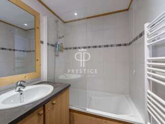Discover a stylish bathroom featuring a sleek sink and a modern shower.