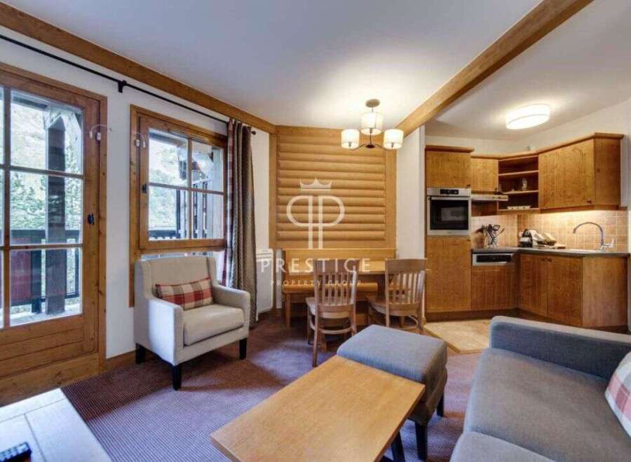 Discover the charm of this cozy property, featuring a warm and inviting interior with wooden accents throughout.