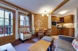 Discover the charm of this cozy property, featuring a warm and inviting interior with wooden accents throughout.