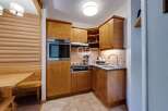 Discover a charming kitchen with wooden cabinetry, perfect for preparing delicious meals.