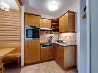 Discover a charming kitchen with wooden cabinetry, perfect for preparing delicious meals.