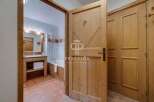 Discover a charming bathroom with a rustic wooden door, offering a warm and inviting atmosphere.
