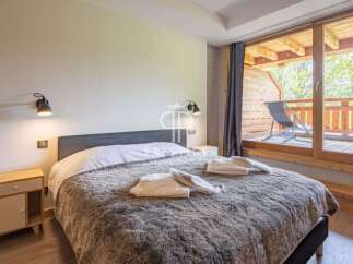 Discover a cozy bedroom with a plush, inviting bed, perfect for relaxation.