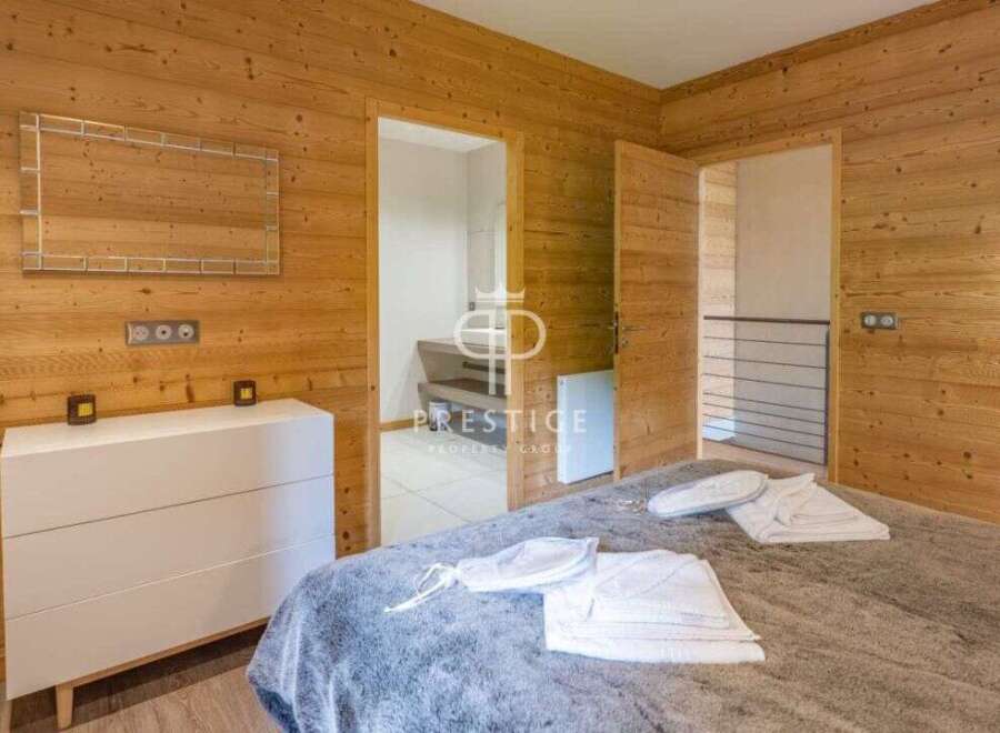 Discover the charm of this cozy bedroom, featuring stunning wood paneling that exudes warmth and character.