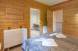 Discover the charm of this cozy bedroom, featuring stunning wood paneling that exudes warmth and character.
