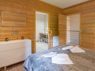 Discover the charm of this cozy bedroom, featuring stunning wood paneling that exudes warmth and character.
