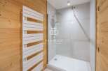 Discover a luxurious bathroom featuring a modern shower and stylish heated towel rack.