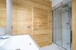 Discover a luxurious bathroom featuring stunning wood paneling that exudes warmth and sophistication.