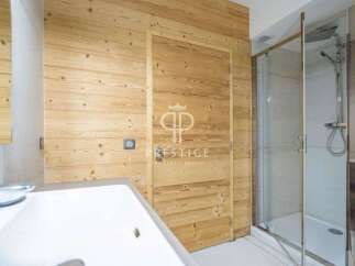 Discover a luxurious bathroom featuring stunning wood paneling that exudes warmth and sophistication.