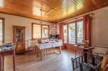 Discover the charm of this inviting property, featuring a warm wooden ceiling and flooring that create a cozy atmosphere.