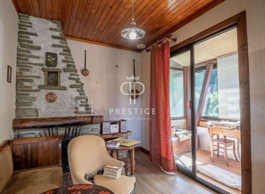 Cozy living space with a rustic stone fireplace, perfect for relaxing evenings.