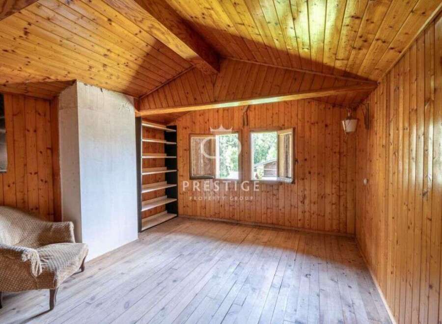 Discover the charm of this cozy cabin with its warm wooden interior.