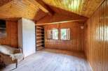 Discover the charm of this cozy cabin with its warm wooden interior.