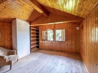 Discover the charm of this cozy cabin with its warm wooden interior.
