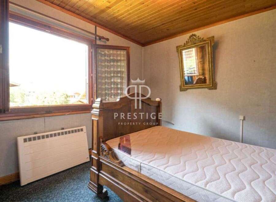 Cozy bedroom with a classic wooden bed frame.