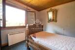 Cozy bedroom with a classic wooden bed frame.