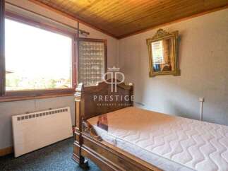 Cozy bedroom with a classic wooden bed frame.