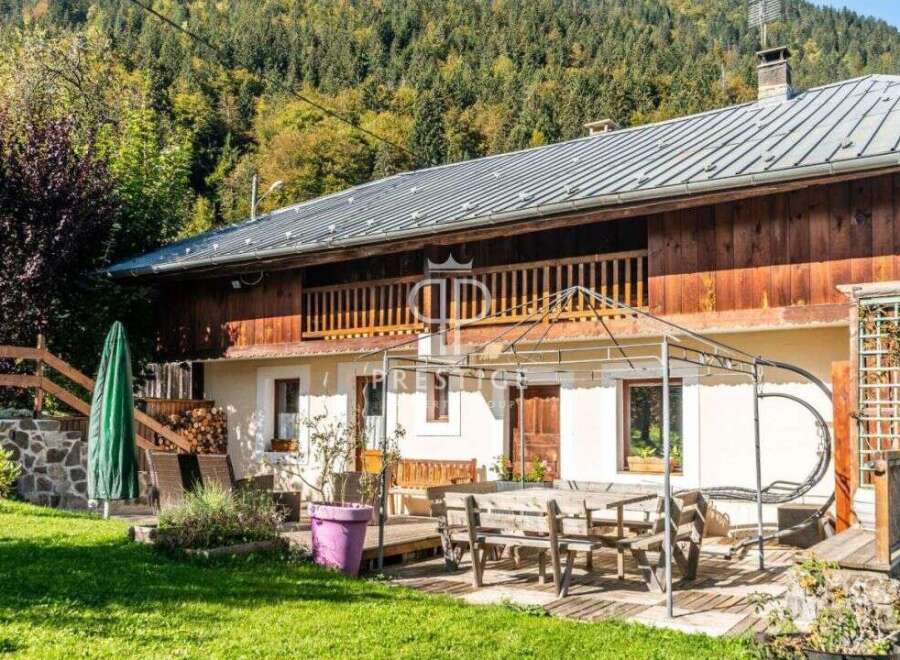 Discover a charming chalet nestled in a picturesque mountain setting.