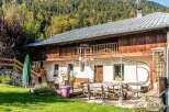 Discover a charming chalet nestled in a picturesque mountain setting.