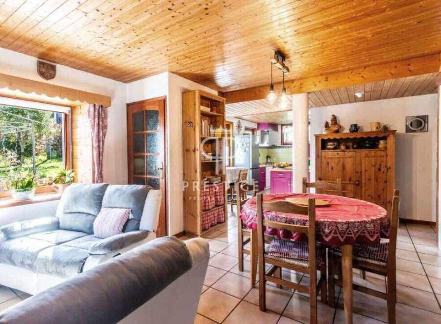 Discover the charm of this cozy property, featuring a warm wooden ceiling and inviting living spaces.