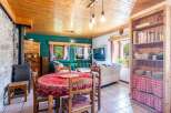 Discover the charm of this cozy property, featuring a warm wooden ceiling and inviting living spaces.