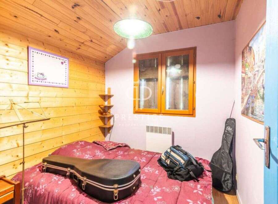 Cozy bedroom with wooden accents and a charming ambiance.