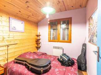 Cozy bedroom with wooden accents and a charming ambiance.