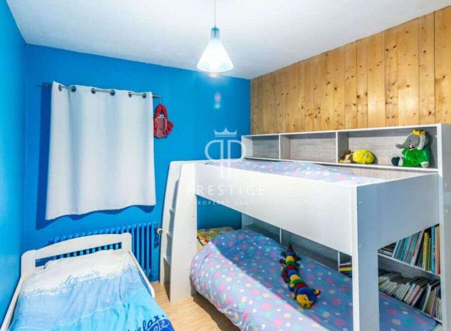 This charming bedroom features a cozy bunk bed, perfect for kids or guests.