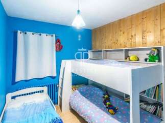 This charming bedroom features a cozy bunk bed, perfect for kids or guests.