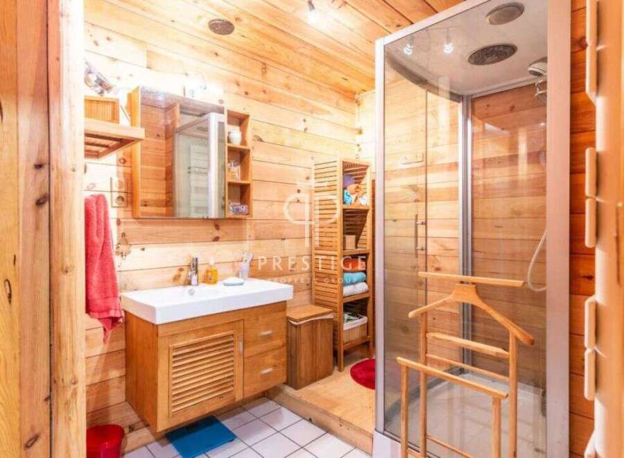 Step into a rustic bathroom retreat, where natural wood paneling creates a warm and inviting atmosphere.