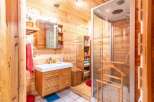 Step into a rustic bathroom retreat, where natural wood paneling creates a warm and inviting atmosphere.