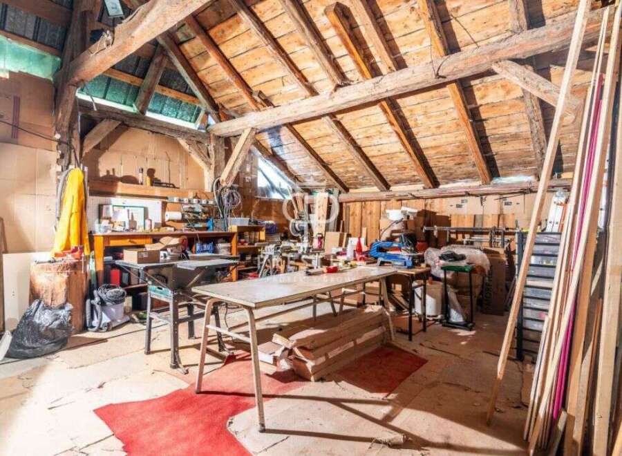 Discover the charm of this unique property! This space boasts a rustic interior with exposed wooden beams and a spacious layout.