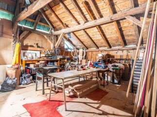 Discover the charm of this unique property! This space boasts a rustic interior with exposed wooden beams and a spacious layout.
