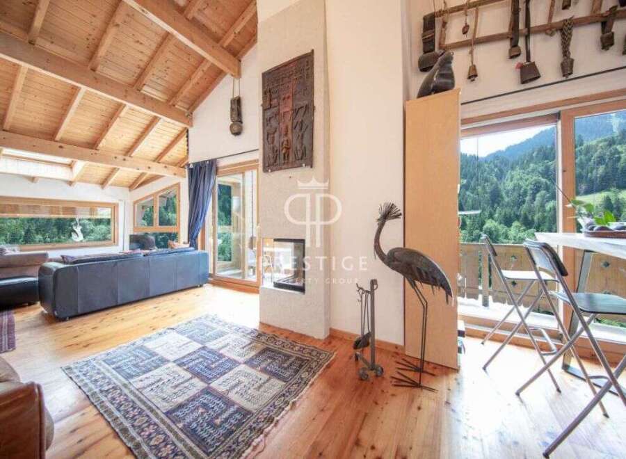 Experience luxury living in this stunning property, featuring a cozy fireplace and a spacious living area.