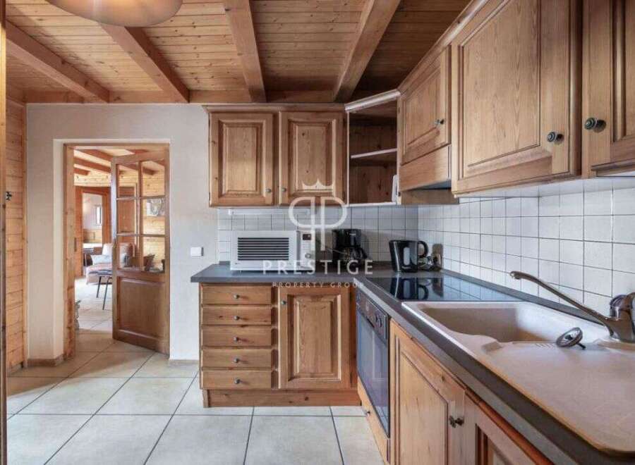 Discover the charm of this kitchen, featuring warm wooden cabinetry and a cozy ambiance.
