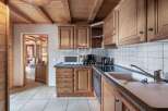 Discover the charm of this kitchen, featuring warm wooden cabinetry and a cozy ambiance.
