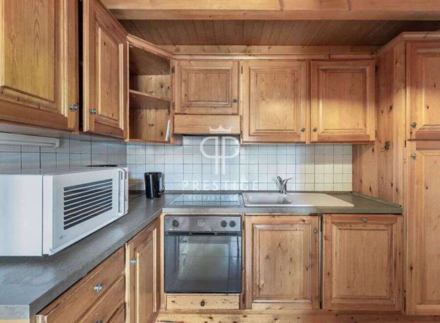 Discover the charm of this cozy kitchen, featuring warm wooden cabinetry and a functional layout.