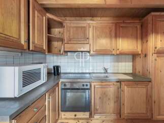 Discover the charm of this cozy kitchen, featuring warm wooden cabinetry and a functional layout.