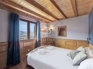 Discover the charm of this cozy bedroom, featuring a stunning wooden ceiling and walls that exude warmth.