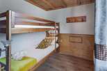 This cozy bedroom features a charming bunk bed, perfect for accommodating guests or family members.