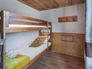 This cozy bedroom features a charming bunk bed, perfect for accommodating guests or family members.