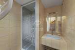 Discover a stylish bathroom featuring a modern shower enclosure and a sleek sink.