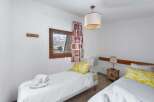Cozy bedroom with twin beds, perfect for a relaxing stay.