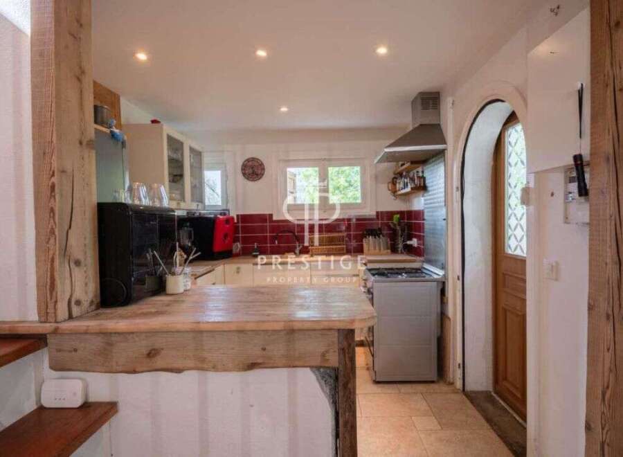 Discover the charm of this property, featuring a rustic kitchen with wooden accents and a cozy atmosphere.